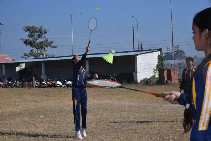 A student serving in badminton