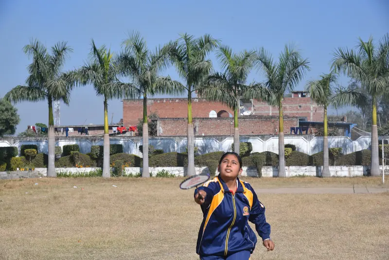 A student playing badminton outdoors