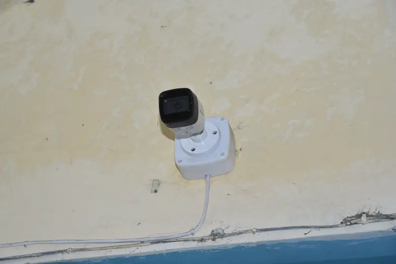 A CCTV camera on a corridor wall