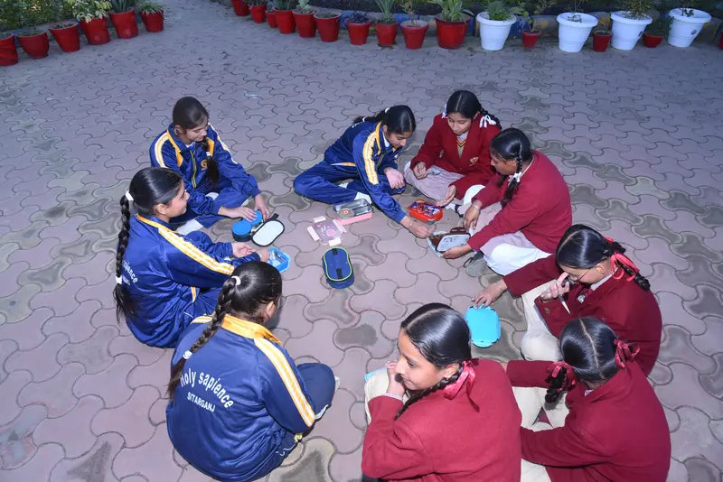 Students drawing together on the courtyard floor