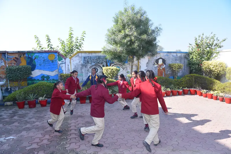 Students playing a circle game in the courtyard