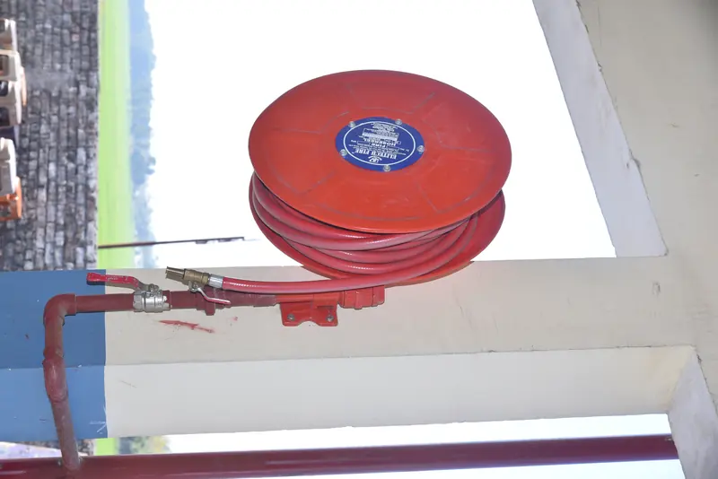 A fire hose reel mounted on the wall