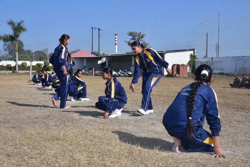Girls playing kho-kho on the ground